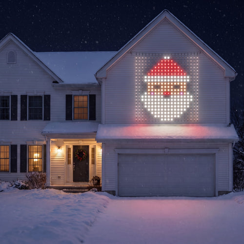 Cheriemood LED curtain showing Santa on the wall above the garage of a snowy American house at night
