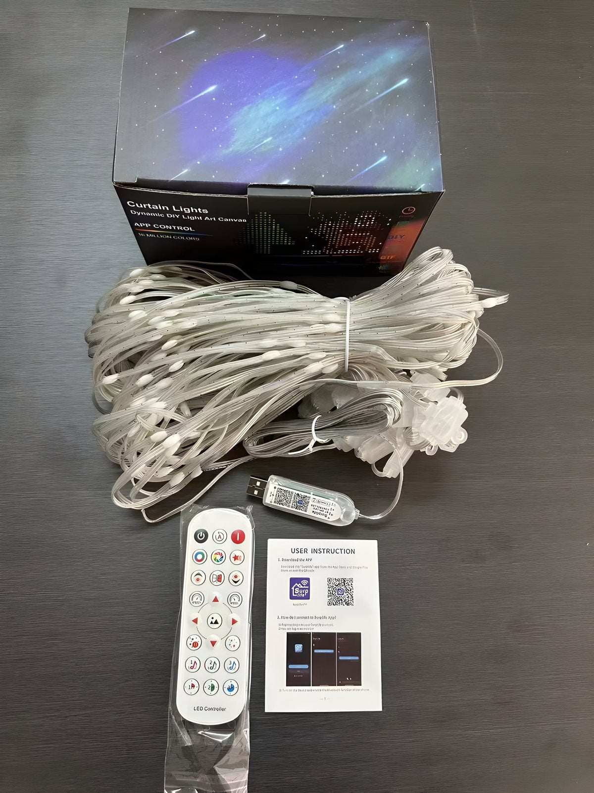 Real photo: Out of the box, the curtain, the USB controller, the remote and the manual.